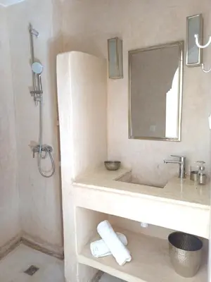 a bathroom with a sink and a mirror at Riad DabaKech in Marrakech
