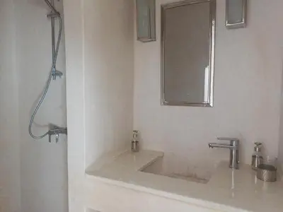 a bathroom with a sink and a mirror at Riad DabaKech in Marrakech