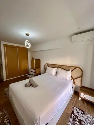a bedroom with a large bed with white sheets and pillows at Appartement à Marrakech 2 chambres avec piscine et parking Palmeraie Gates in Marrakech