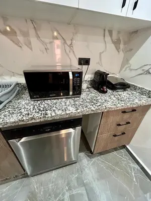 a microwave sitting on a counter in a kitchen at Appartement à Marrakech 2 chambres avec piscine et parking Palmeraie Gates in Marrakech