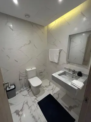 a white bathroom with a sink and a toilet at Appartement à Marrakech 2 chambres avec piscine et parking Palmeraie Gates in Marrakech
