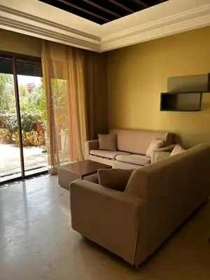 a living room with a couch and a table at Vizir Center Apartment Marrakech A103 in Marrakech