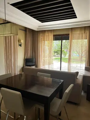 a living room with a black table and chairs at Vizir Center Apartment Marrakech A103 in Marrakech
