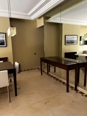 a dining room with a table and a couch at Vizir Center Apartment Marrakech A103 in Marrakech