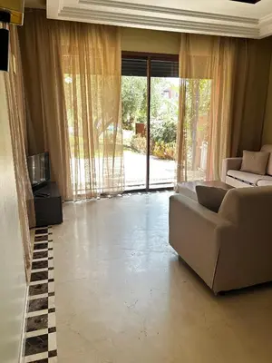 a living room with a couch and a large window at Vizir Center Apartment Marrakech A103 in Marrakech