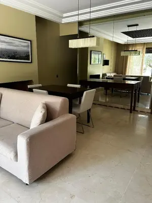 a living room with a couch and a table at Vizir Center Apartment Marrakech A103 in Marrakech