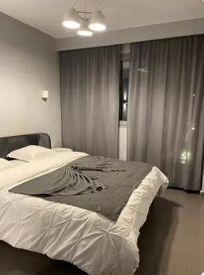 a bedroom with a large bed with white sheets at Charming Apartment Heart of Marrakech in Marrakech