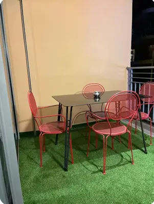 a table with red chairs and a table with grass at Ideal stay near Medina and historical sites in Marrakech