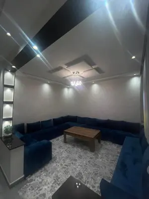 a living room with blue couches and a table at Cozy Part in Marrakech