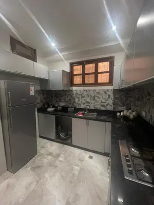 a kitchen with a sink and a stove in it at Cozy Part in Marrakech