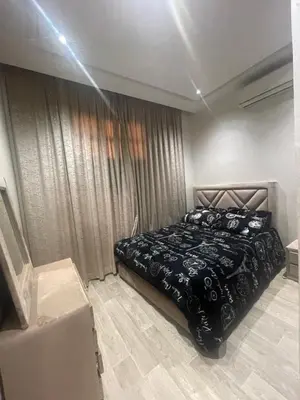a bedroom with a bed with a black blanket at Cozy Part in Marrakech