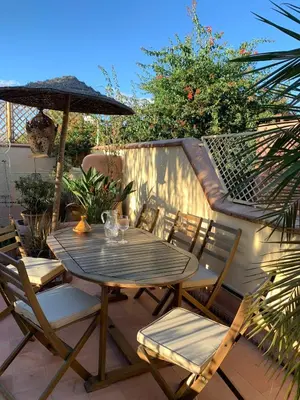 a table and chairs with an umbrella on a patio at RIAD VERT de Nina in Marrakech