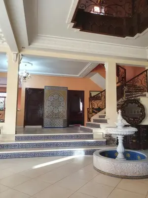 a lobby with a fountain in the middle of a building at Villa with private pool in the center of marrakech in Marrakech