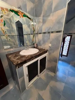 a bathroom with a sink and a mirror at Villa with private pool in the center of marrakech in Marrakech