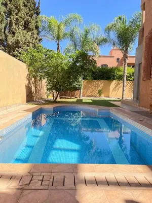 a swimming pool in a yard with trees at Villa with private pool in the center of marrakech in Marrakech
