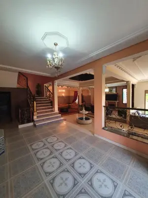 a living room with a staircase and a chandelier at Villa with private pool in the center of marrakech in Marrakech