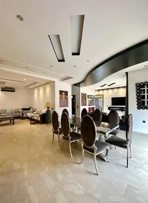 a living room with chairs and a table and a couch at 5-star luxury villa with private pool in Marrakech