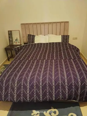 a large bed with a purple and white striped comforter at Chicafrik in Marrakech