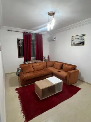 a living room with a brown couch and a table at Chicafrik in Marrakech