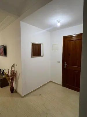 a room with a door and a vase on the floor at Chicafrik in Marrakech
