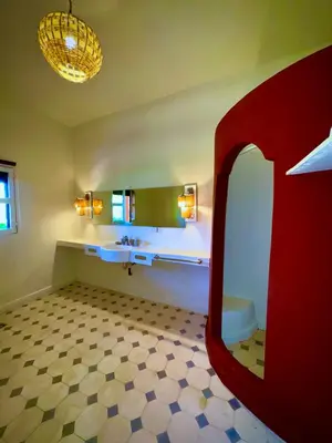 a bathroom with a red sink and a mirror at Domaine JJ in Marrakech