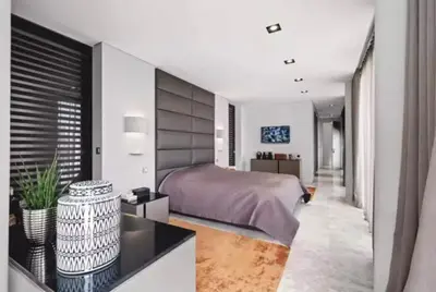 a bedroom with a bed and a desk in a room at Beautiful palm tree villa in Marrakech