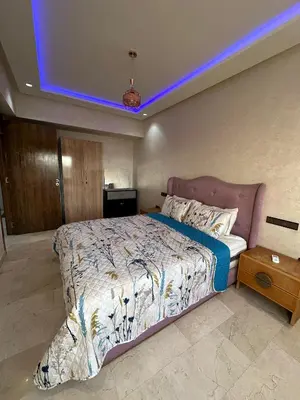 a bedroom with a large bed with a blue light at Appartement a Marrakech centre in Marrakech