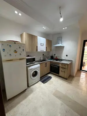 a kitchen with a white refrigerator and a dishwasher at Appartement a Marrakech centre in Marrakech