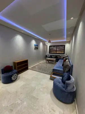 a living room with two blue chairs and a couch at Appartement a Marrakech centre in Marrakech