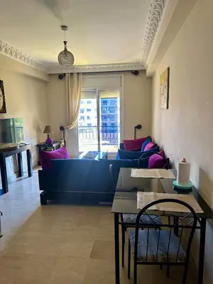 a living room with a couch and a table at apartement centre gueliz in Marrakech