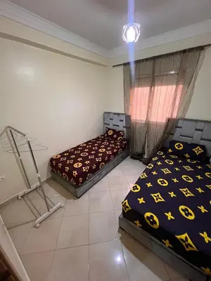 a bedroom with two beds and a window at 2BR w Balcony in Gueliz 2 Bedroom Apartment with Balcony in Gueliz in Marrakech