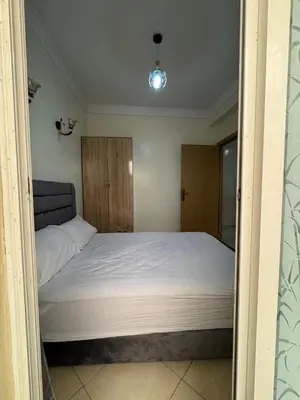 a bedroom with a large bed with white sheets at 2BR w Balcony in Gueliz 2 Bedroom Apartment with Balcony in Gueliz in Marrakech