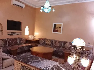 a living room with a couch and a table at Riad Yousra in Marrakech