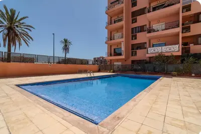 a swimming pool in front of a building at Rooftop Sun Pool Chic Apartment Perfect Stay in Marrakech
