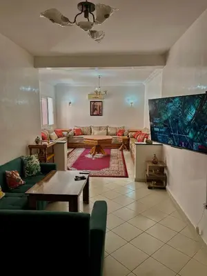 a living room with a couch and a table at Appartement a louer in Marrakech