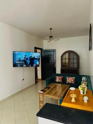 a living room with a couch and a table at Appartement a louer in Marrakech