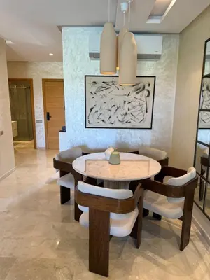 a dining room with a table and chairs at Elegant Apartment in Prestigia Pool & Golf in Marrakech