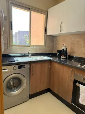 a kitchen with a washing machine and a window at Elegant Apartment in Prestigia Pool & Golf in Marrakech