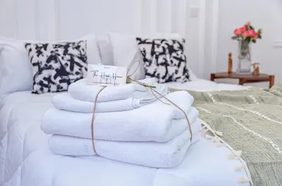 a pile of towels sitting on top of a bed at NEW Cocon cosy au coeur de Marrakech in Marrakech