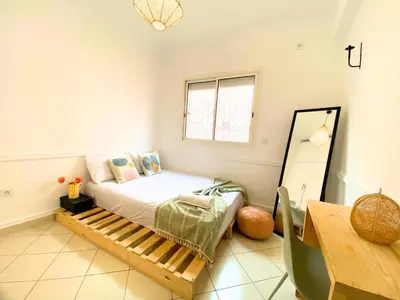 a small bedroom with a bed and a table at NEW Cocon cosy au coeur de Marrakech in Marrakech