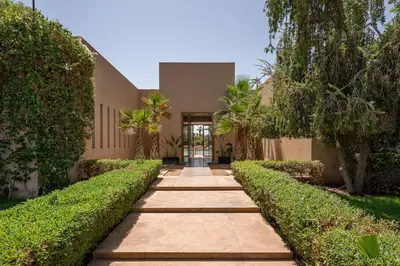 a walkway in front of a building with trees at Villa Sofya Domaine exceptionnel 10 suites & piscine privée in Marrakech
