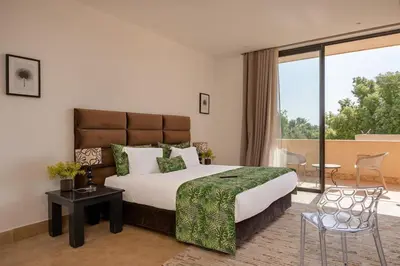 a bedroom with a large bed and a balcony at Villa Sofya Domaine exceptionnel 10 suites & piscine privée in Marrakech