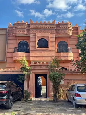 a building with two cars parked in front of it at Villa Route de Casa in Marrakech