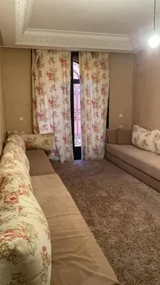 a living room with two beds and a window at Villa Route de Casa in Marrakech