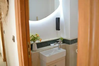 a bathroom with a sink and a mirror at Menara Palms Marrakech in Marrakech