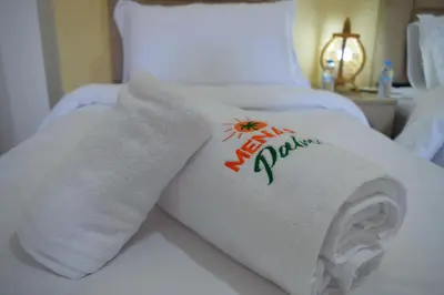 a white towel on top of a bed at Menara Palms Marrakech in Marrakech