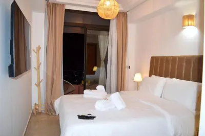 a hotel room with a bed with towels on it at Menara Palms Marrakech in Marrakech