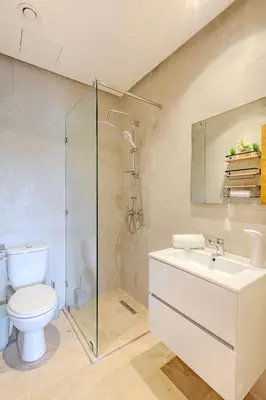 a bathroom with a shower and a toilet and a sink at Luxury Apartment - Prestigia Golf City Marrakech in Marrakech