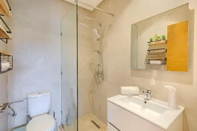 a bathroom with a toilet and a sink and a shower at Luxury Apartment - Prestigia Golf City Marrakech in Marrakech
