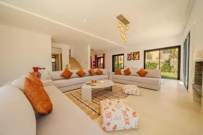 a living room with white furniture and a fireplace at Villa Assia Modern Luxury Private Pool in Marrakech